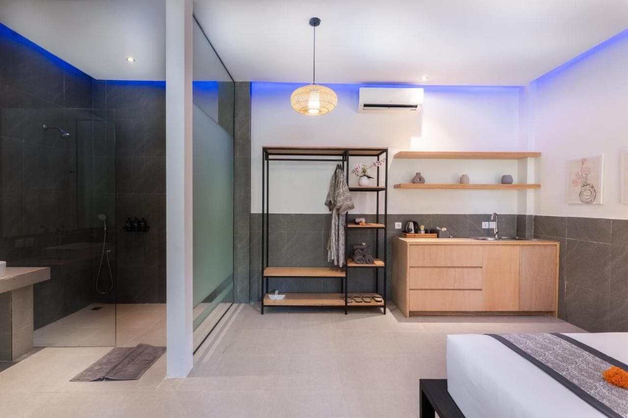 a bathroom with a shower and a bed and a sink at Lula Boutique by The Studios Ubud Adult Only in Ubud