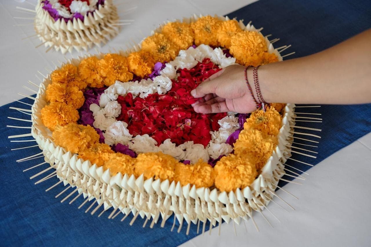 a person is reaching for a heart shaped cake at Tigata Ubud Cottage in Ubud