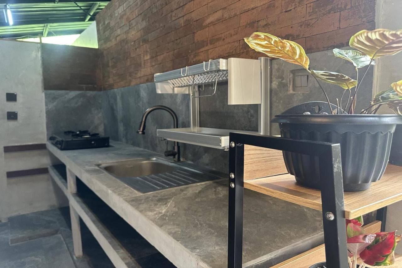 a kitchen with a sink and a potted plant at Nawan Nusa Dua Bali in Nusa Dua