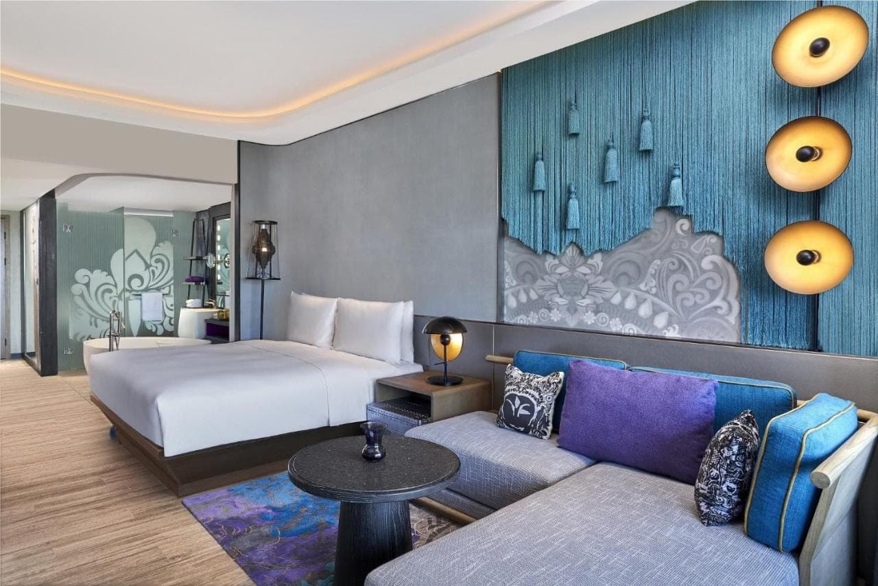 a hotel room with a bed and a couch at Renaissance Bali Nusa Dua Resort in Nusa Dua
