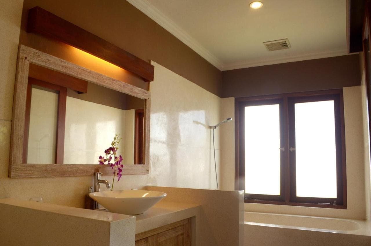 a bathroom with a sink and a mirror at The Bali Shanti in Ubud