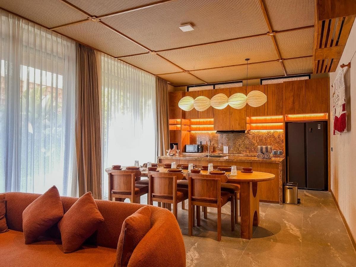 a dining room and kitchen with a table and chairs at TUI BLUE Berawa Hotel and Villas in Canggu