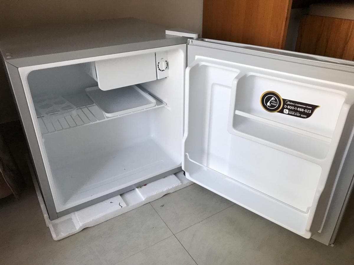 an empty refrigerator with its door open in a kitchen at Villa Pulu Uluwatu Bali in Uluwatu