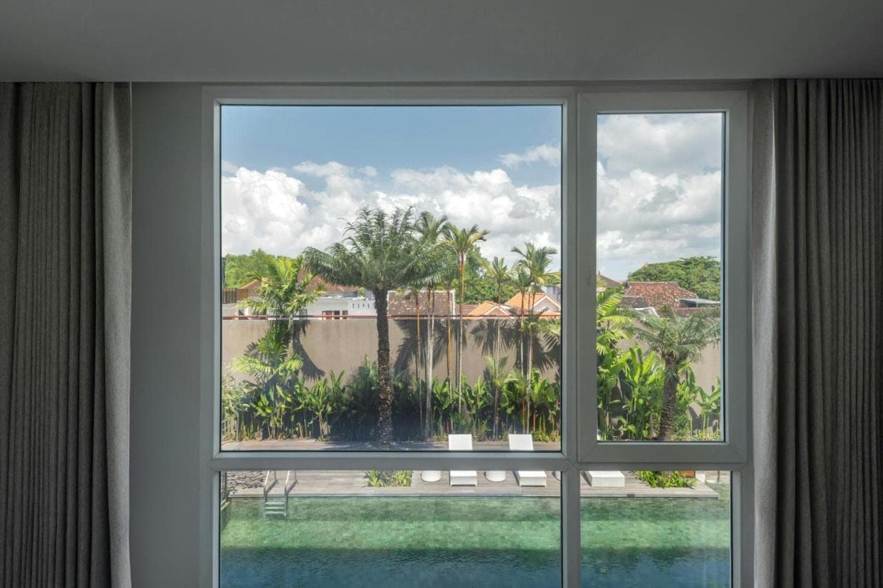 a window in a hotel room looking out at a pool at Fairfield by Marriott Bali Kuta Ngurah Rai in Kuta