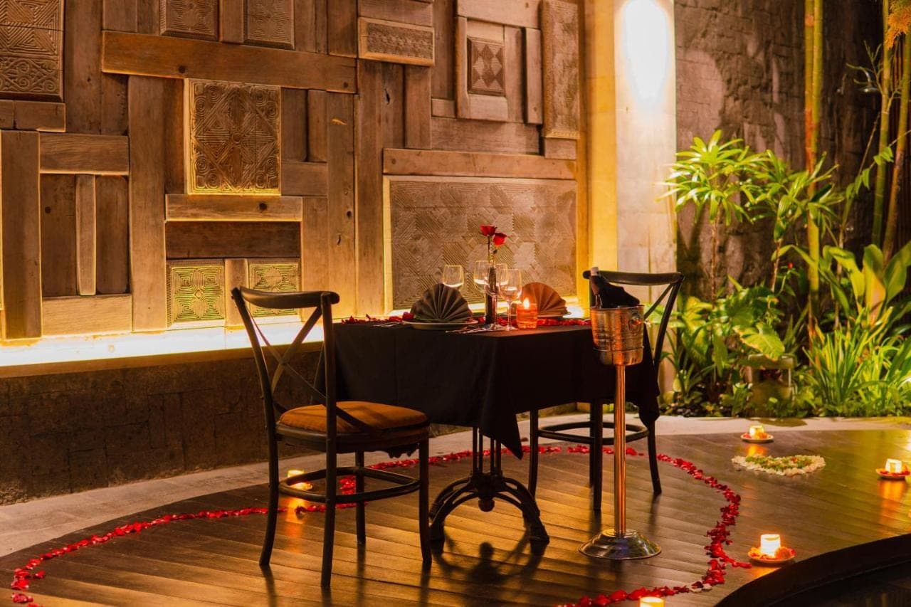a table with two chairs and a table with candles at Akana Boutique Hotel in Sanur