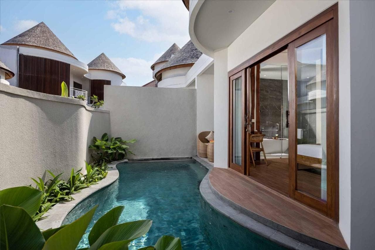a swimming pool in the backyard of a villa at The Prime Canggu Bali by Kanaya Hospitality in Canggu