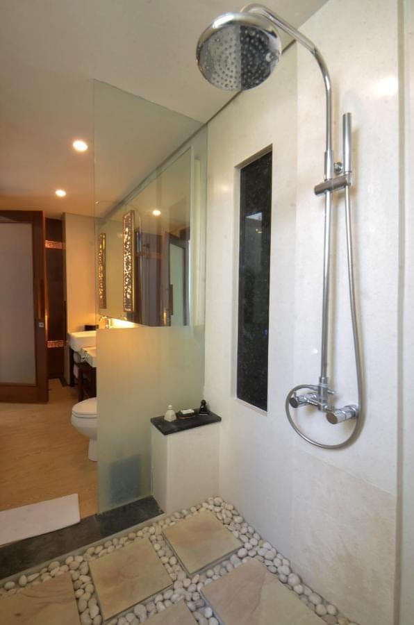 a bathroom with a shower and a toilet at Puri Hiromi Boutique Residence in Sanur