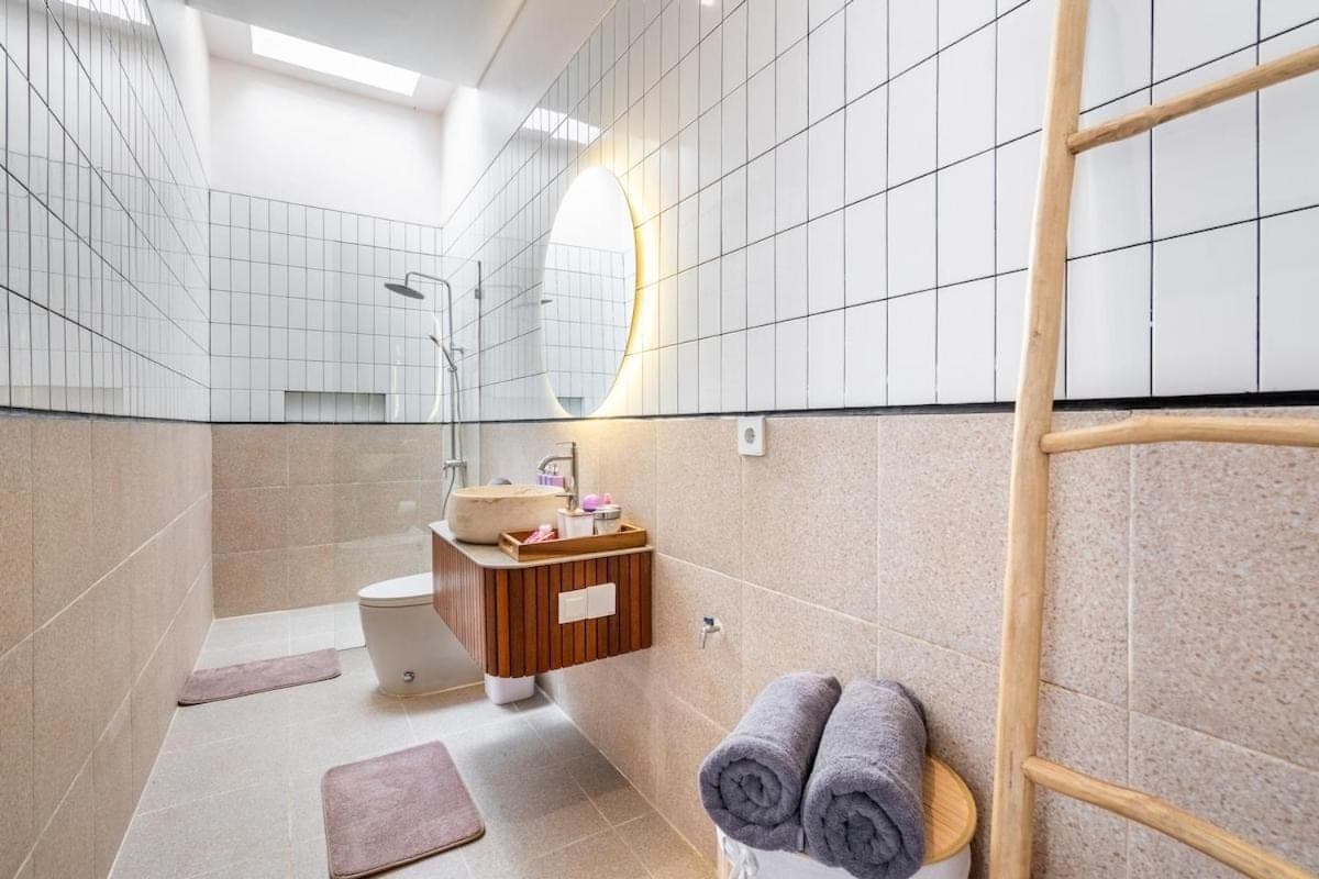 a bathroom with a shower and a toilet and a sink at Awaken your Mind and Body in the Solari Butterfly Villa in Sanur
