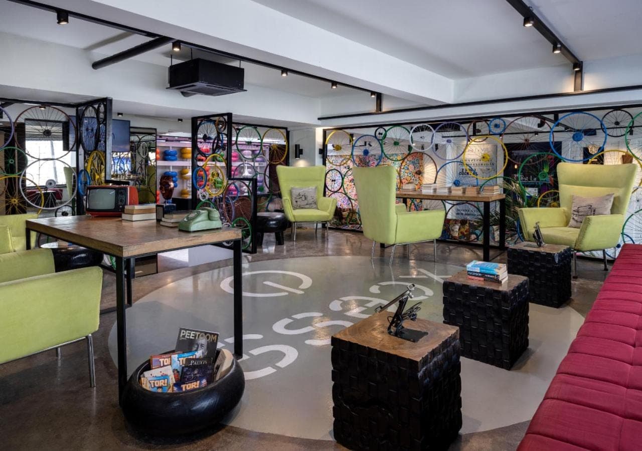 a restaurant with colorful chairs and tables in a room at Viva Dash Hotel Seminyak in Seminyak