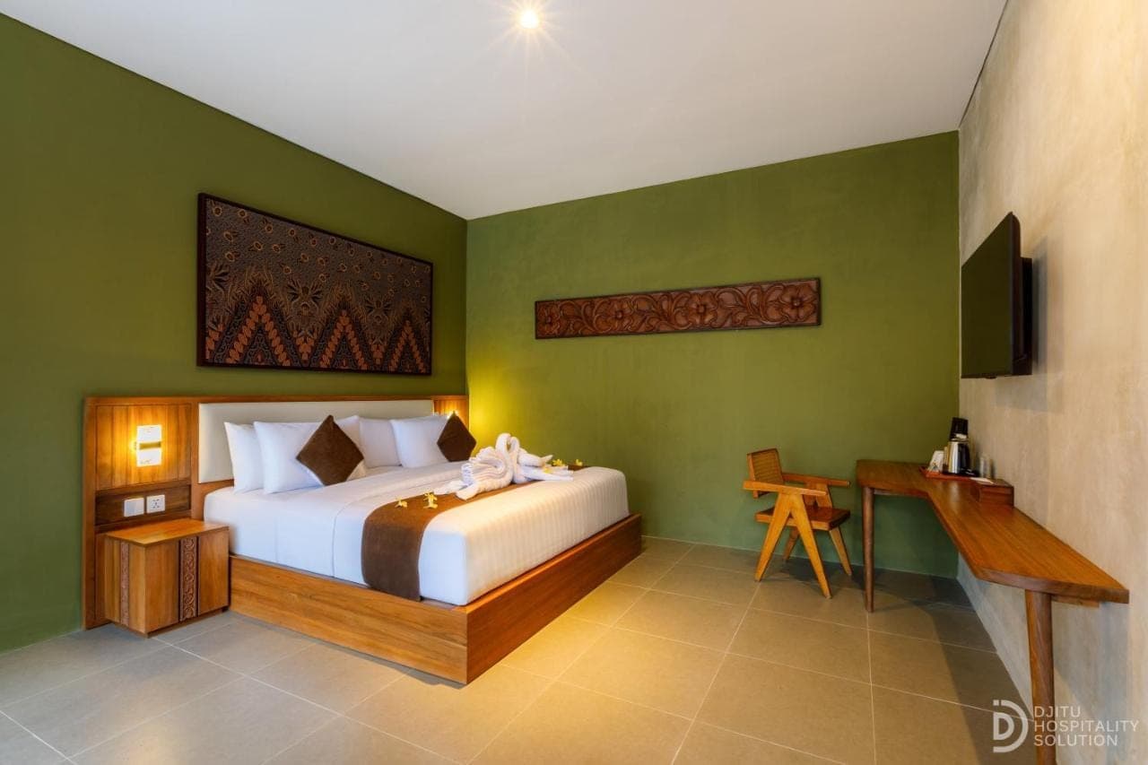 a bedroom with a bed and a desk in it at ME Villa Pererenan in Canggu