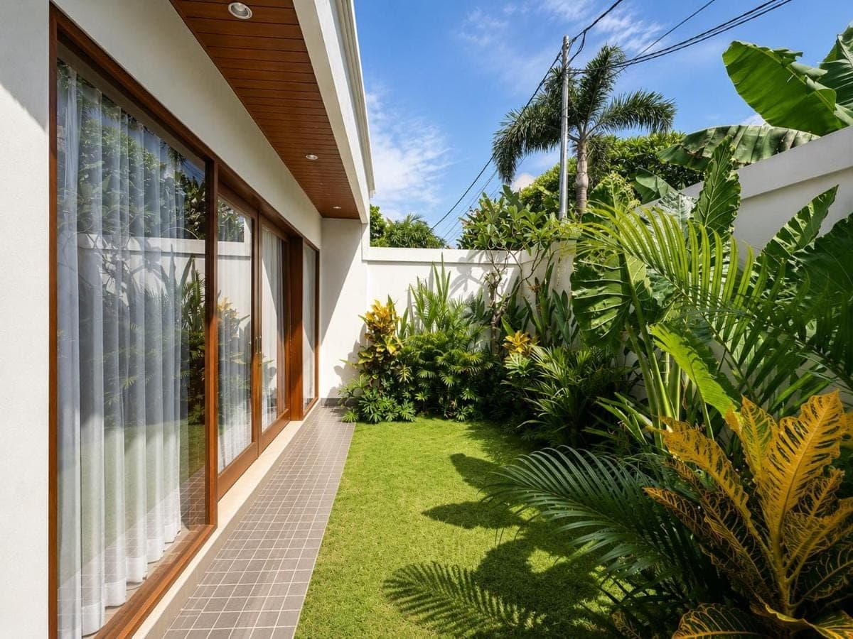 a garden outside a house with green plants at Mahayasa Hidden Retreats 1BR Garden Villa in Canggu