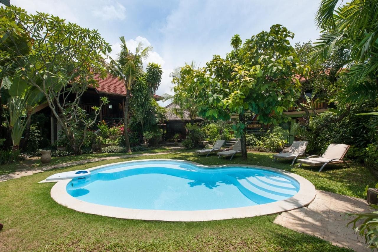 a swimming pool in the yard of a house at Pondok Agung Bed & Breakfast in Nusa Dua