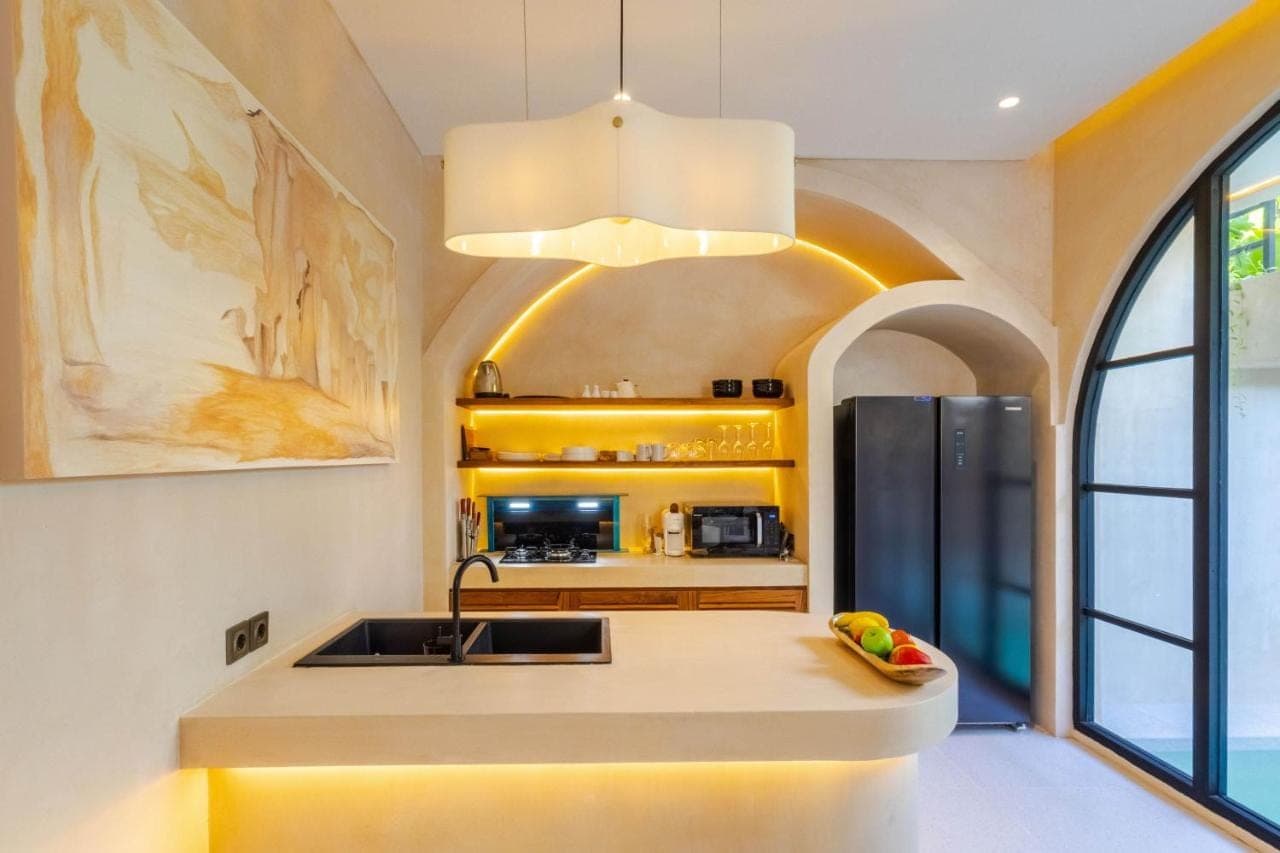 a kitchen with a sink and a refrigerator at Villa San Miguel by Pertama Stay in Seminyak