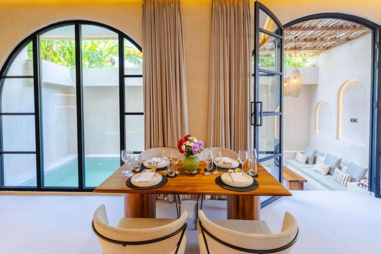 a dining room with a table and chairs at Villa San Miguel by Pertama Stay in Seminyak