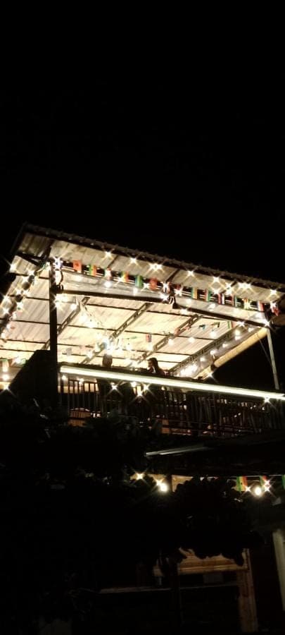 a building lit up at night with lights on it at Beten Enjung Home Stay&rooftop in Amed